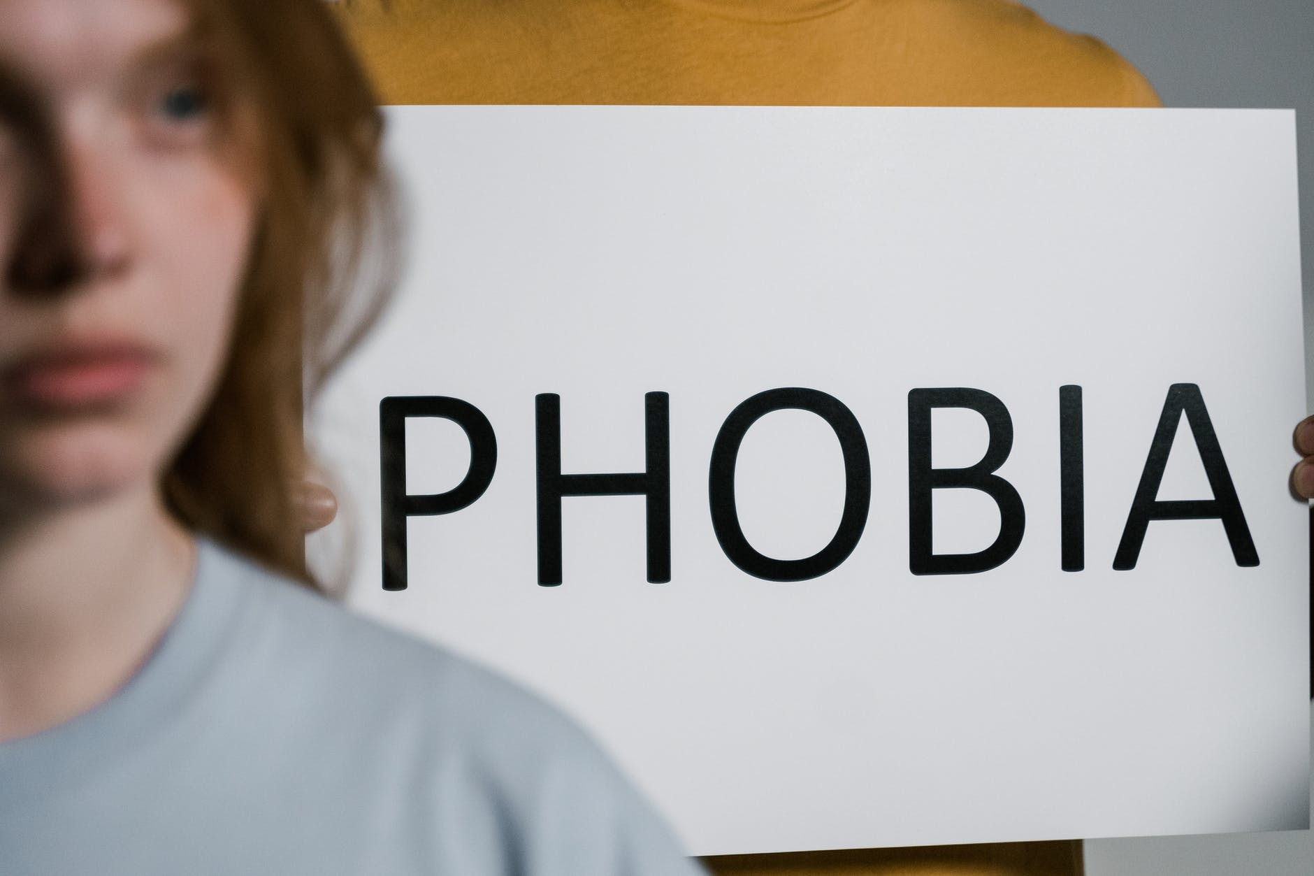 a person holding a sign of phobia