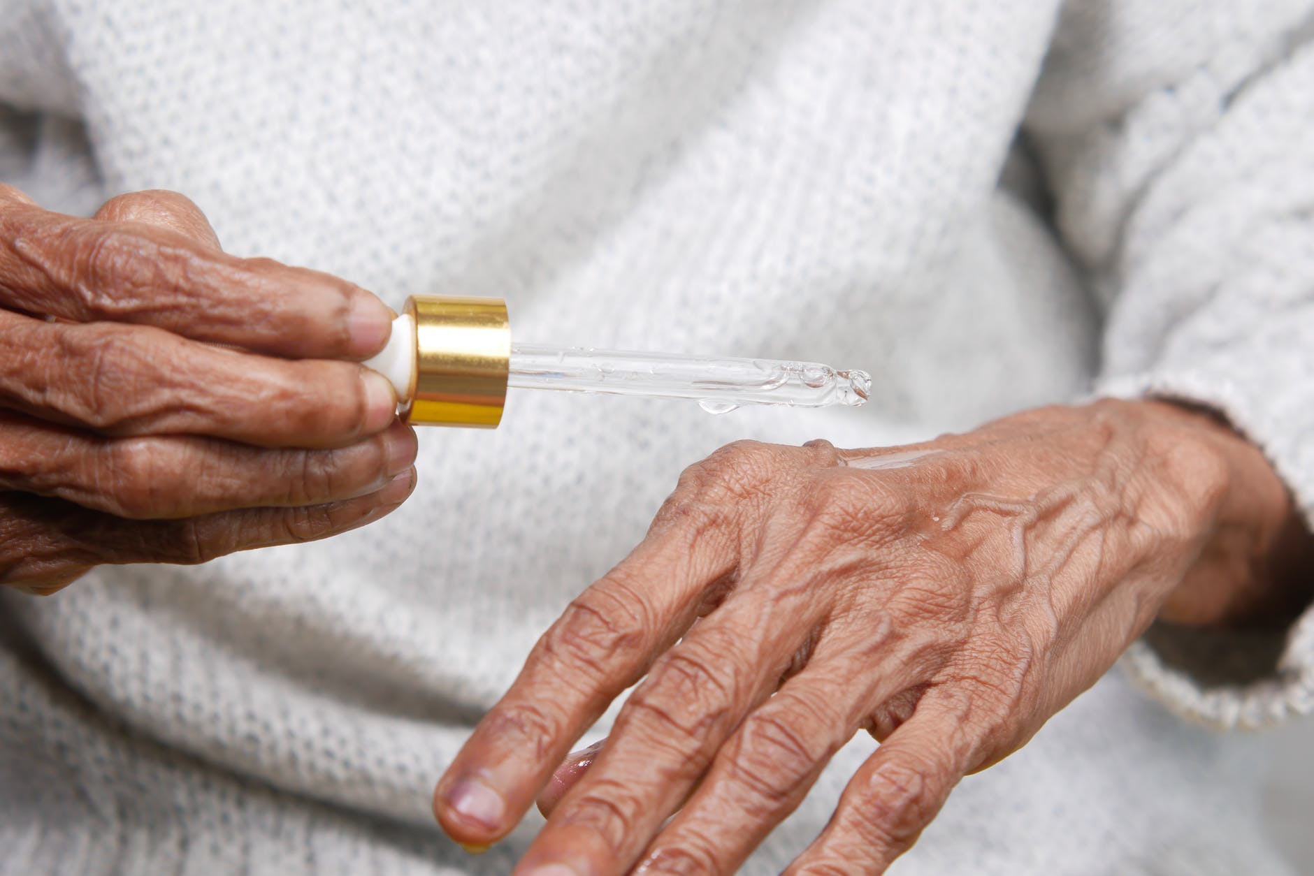 person holding yellow and silver tube