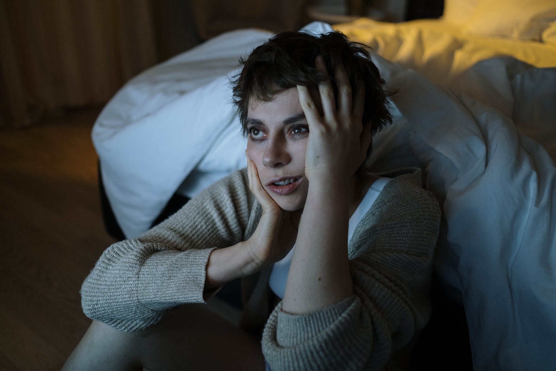 photograph of a woman touching her face insomnia is one of the subtle signs of anxiety