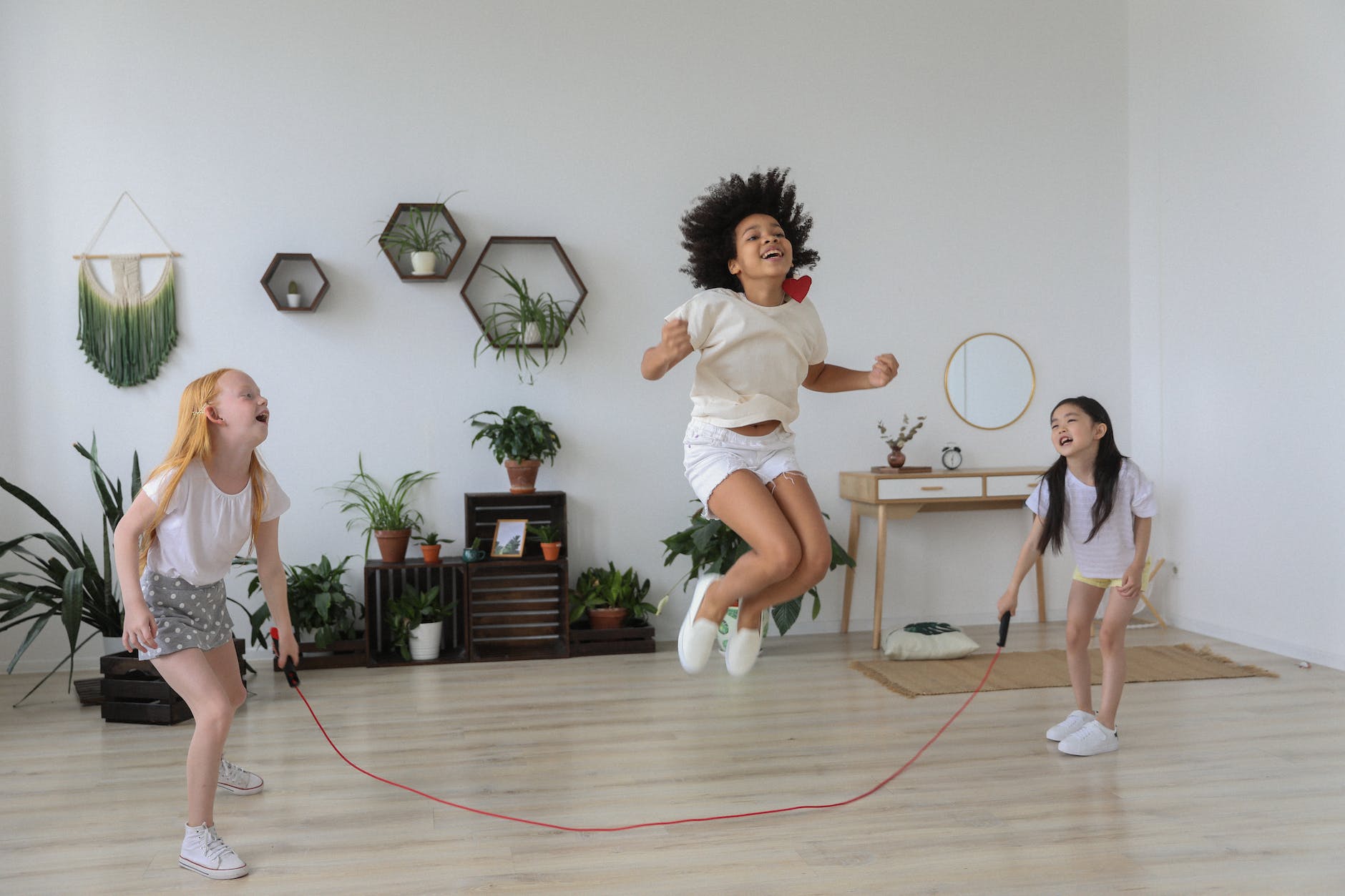 black girl jumping over rope while playing with friends fun ways to exercise