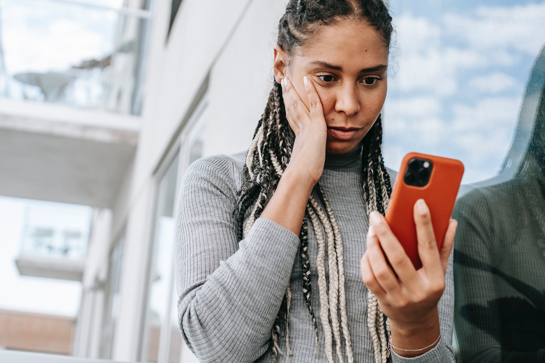 crop concerned black woman using smartphone on street fault vs responsibility